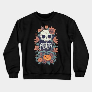 A Skeleton standing in front of flowers and a Halloween pumpkin beside it. Crewneck Sweatshirt